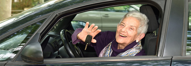 Seniorenautofahrerin im Auto mit Autoschlüssel in der Hand