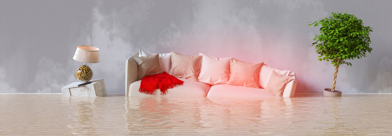 Sofa und Lampe eines Zimmers schwimmen im Wasser