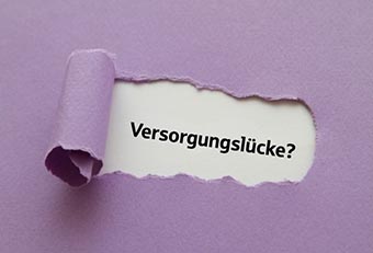 Aufgerissenes Papier mit dem Wort Versorgungslücke als Symbol für Vorsorge und finanzielle Absicherung