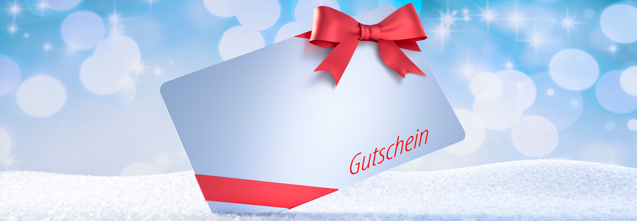 Bildmontage: Geschenkgutschein vor winterlichem Hintergrund