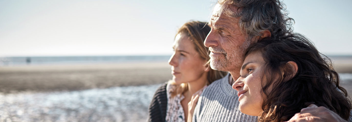 Vater ist mit seinen zwei Töchtern am Strand. 